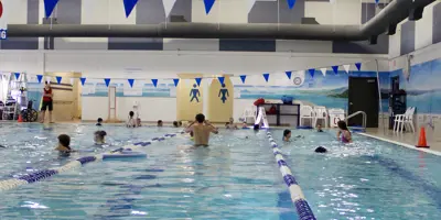 People swimming and playing in an indoor pool